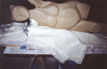 The rubber liner is peeled away from the clay, which will be replaced with wax.